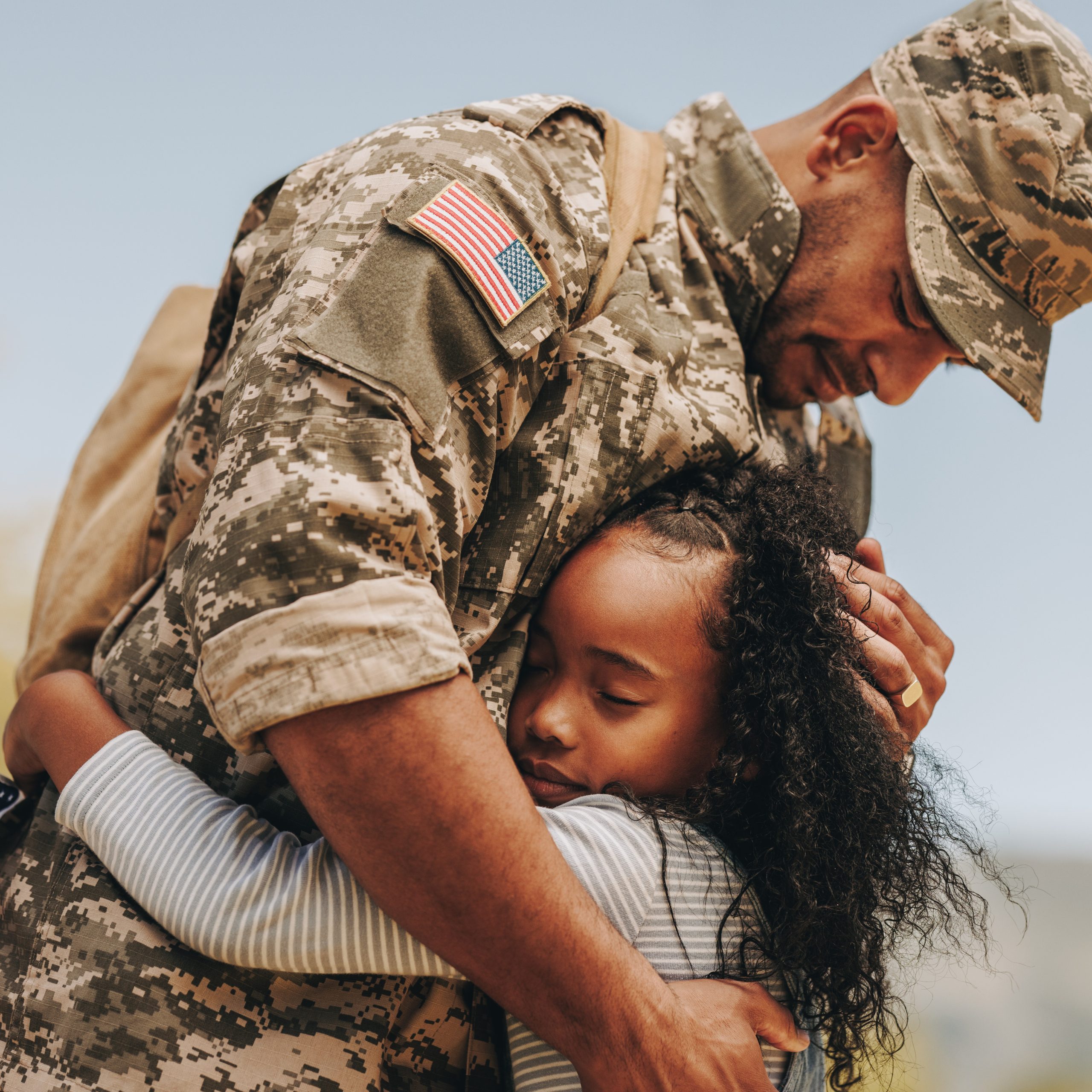 Affectionate military reunion between father and daughter